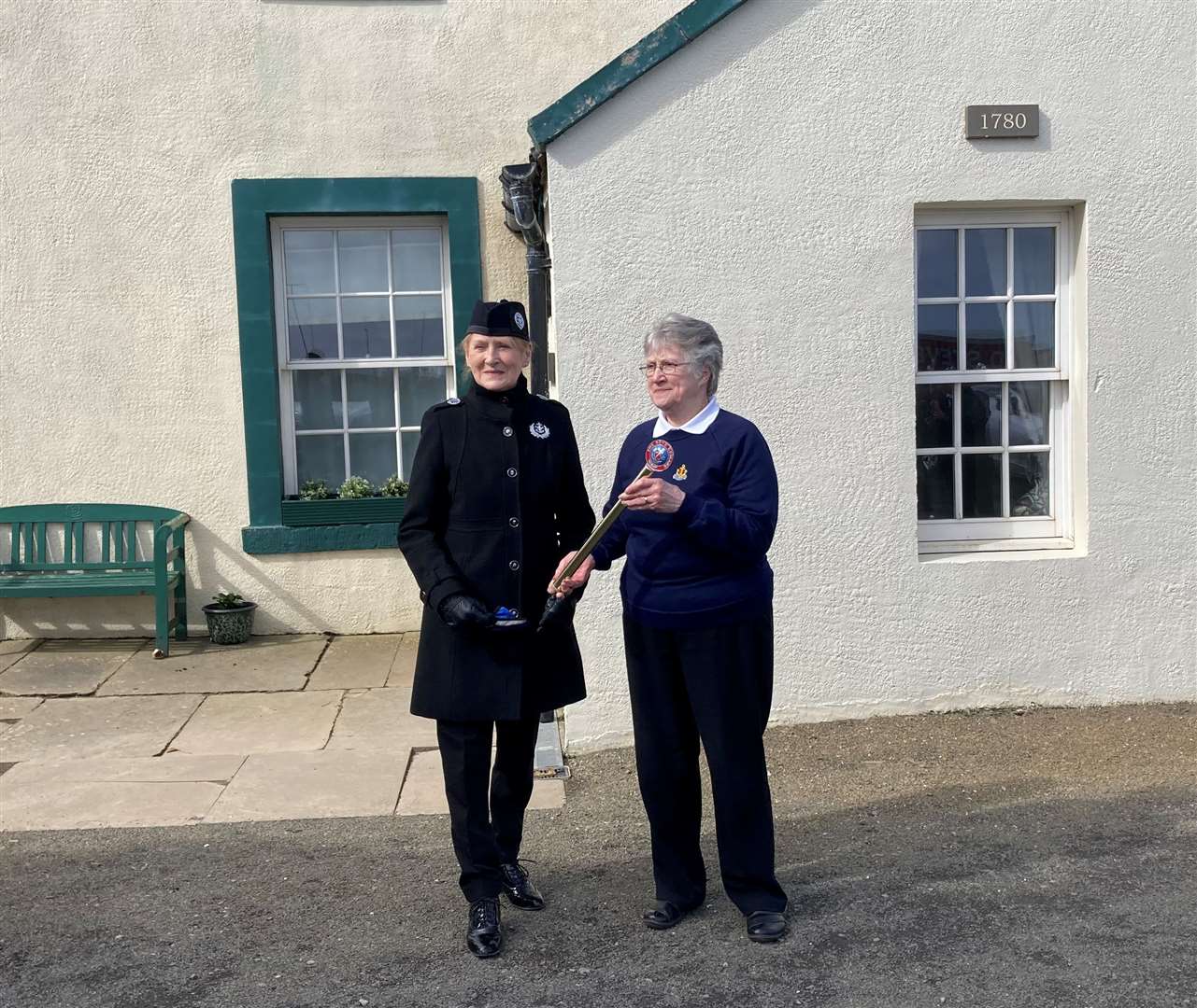 The baton is handed over to Esther Slater, Orkney Battalion Boys’ Brigade, by Johanna Geddes of 1st Thurso at Pennyland House.